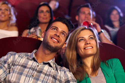 Photo: Happy couple watching movie in cinema Happy couple watching movie in cinema
