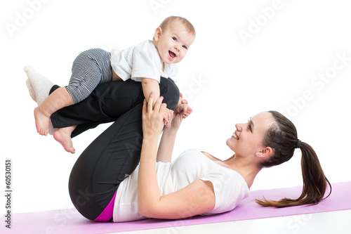 Photo: mother with baby doing gymnastics and fitness exercises mother with baby doing gymnastics and fitness exercises