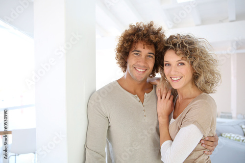 Photo: Attractive smiling couple in new home Attractive smiling couple in new home