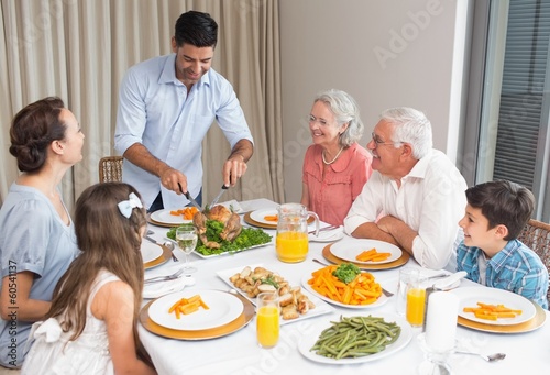 Photo: Extended family at dining table in house Extended family at dining table in house