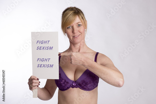 Photo: Mature female protester holding Fight Sexism poster Mature female protester holding Fight Sexism poster