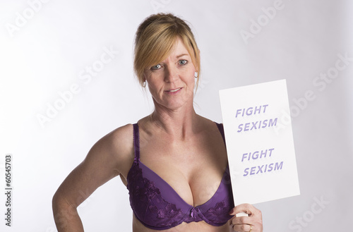 Photo: Mature female protester holding Fight Sexism poster Mature female protester holding Fight Sexism poster