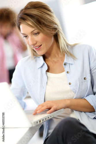 Photo: Smiling businesswoman working in office Smiling businesswoman working in office