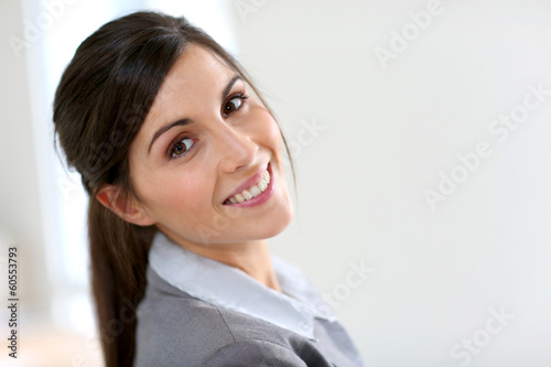 Photo: Smiling business girl standing on white background Smiling business girl standing on white background