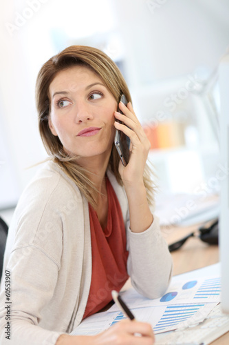 Photo: Portrait of confident businesswoman talking on the phone Portrait of confident businesswoman talking on the phone