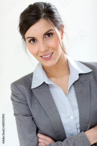Photo: Smiling business girl standing on white background Smiling business girl standing on white background