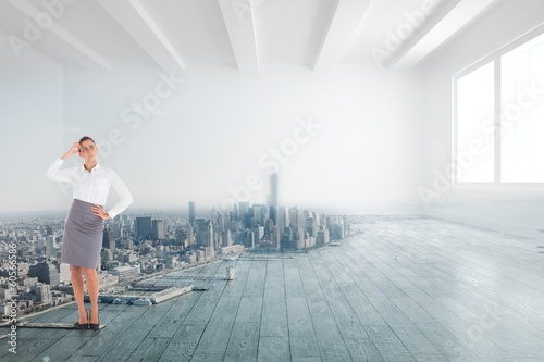 Photo: Composite image of focused businesswoman Composite image of focused businesswoman