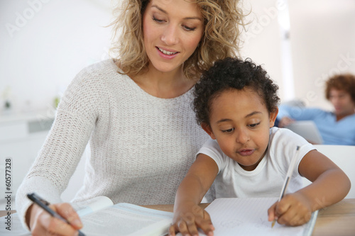 Photo: Mom and kid at home making drawing Mom and kid at home making drawing