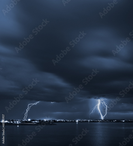 Photo: Signs - powerful lightning strikes over a lake in the city Signs - powerful lightning strikes over a lake in the city