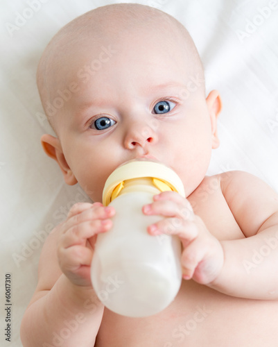 Photo: adorable child drinking from bottle adorable child drinking from bottle