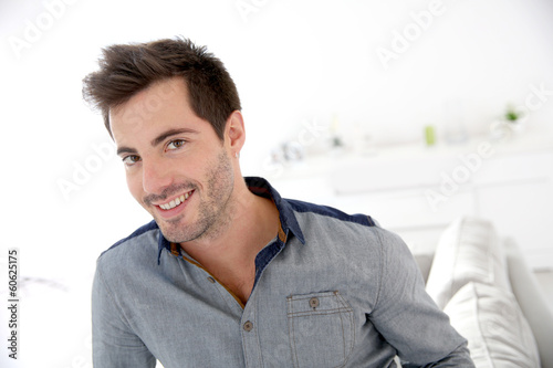Photo: Smiling handsome man looking at camera Smiling handsome man looking at camera