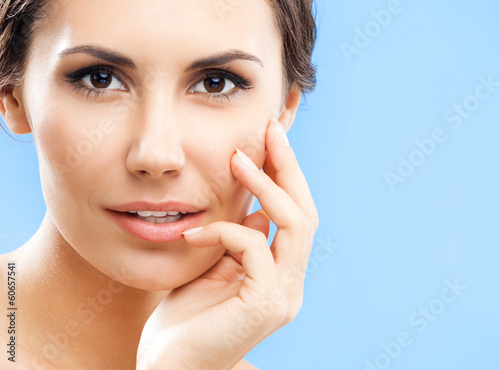 Photo: Portrait of beautiful woman, on blue Portrait of beautiful woman, on blue