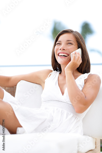 Photo: Phone woman talking on smartphone - on sofa Phone woman talking on smartphone - on sofa