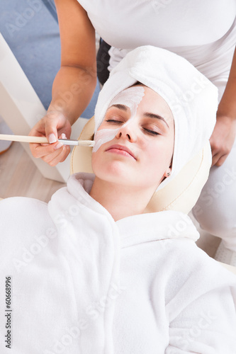 Photo: Therapist Applying Face Mask To Woman Therapist Applying Face Mask To Woman