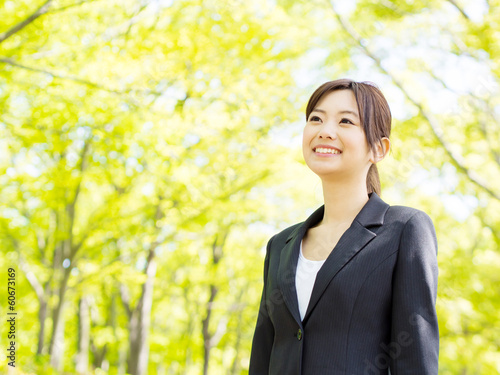 Photo: young asian businesswoman relaxing in the park young asian businesswoman relaxing in the park