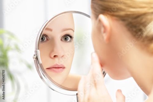 Photo: young beautiful healthy woman and reflection in the mirror young beautiful healthy woman and reflection in the mirror