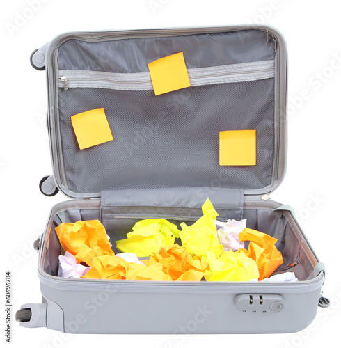 Photo: Open suitcase with paper stickers isolated on white Open suitcase with paper stickers isolated on white