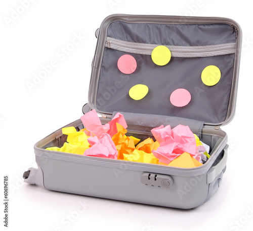 Photo: Open suitcase with paper stickers isolated on white Open suitcase with paper stickers isolated on white