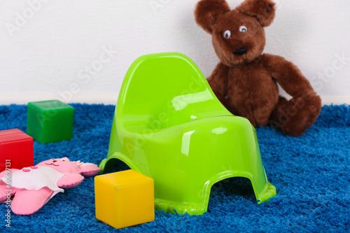 Photo: Green potty on home interior background Green potty on home interior background
