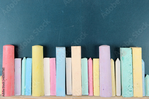 Photo: Colorful chalks on school desk Colorful chalks on school desk
