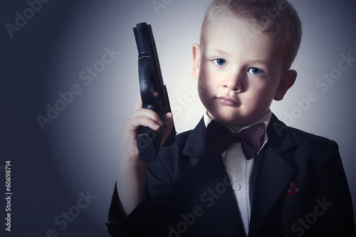 Photo: Handsome Boy with Gun.Fashionable Spy in Suit.Little James Bond Handsome Boy with Gun.Fashionable Spy in Suit.Little James Bond