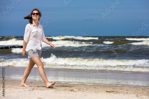 Photo: Teenage girl walking on beach Teenage girl walking on beach