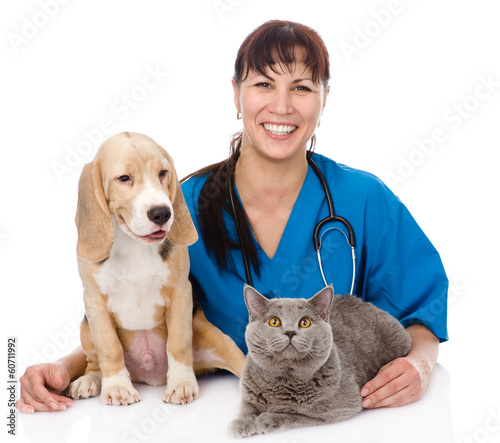 Photo: laughing veterinarian hugging cat and dog. isolated on white laughing veterinarian hugging cat and dog. isolated on white