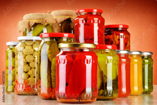 Photo: Composition with jars of pickled vegetables. Marinated food Composition with jars of pickled vegetables. Marinated food