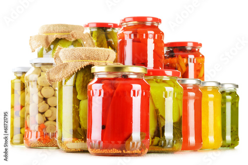 Photo: Composition with jars of pickled vegetables. Marinated food Composition with jars of pickled vegetables. Marinated food