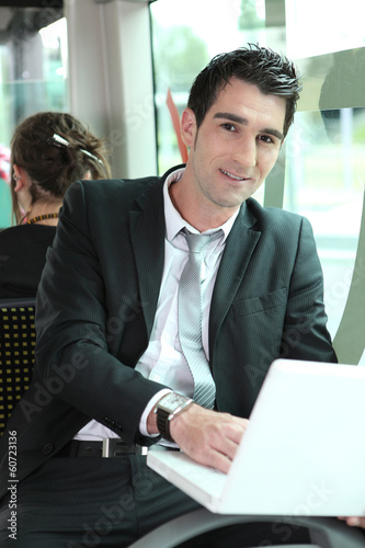 Photo: Businessman working on the bus Businessman working on the bus