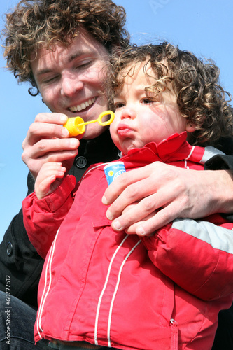 Photo: Father and son blowing bubbles Father and son blowing bubbles