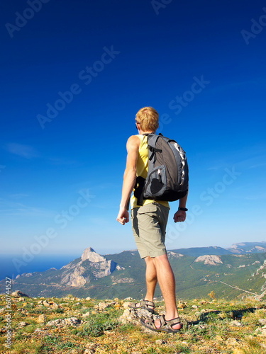 Photo: Climber on the mountain top. Sport concept Climber on the mountain top. Sport concept