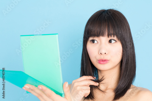 Photo: attractive asian woman on blue background attractive asian woman on blue background