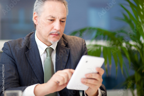 Photo: Businessman using a tablet Businessman using a tablet