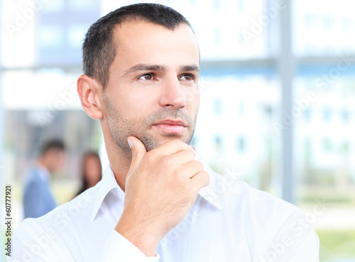Photo: Thoughtful businessman. Handsome man thinking Thoughtful businessman. Handsome man thinking