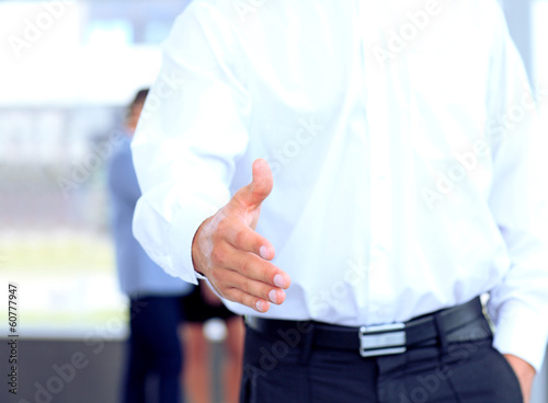 Photo: A business man with an open hand ready to seal a deal A business man with an open hand ready to seal a deal