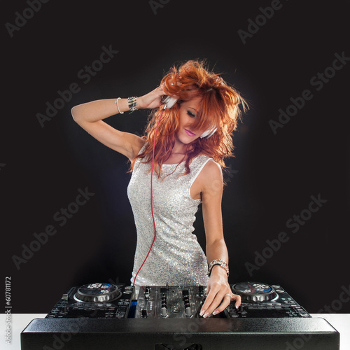 Photo: Young sexy deejay woman against black background. Young sexy deejay woman against black background.