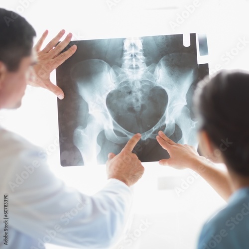 Photo: Nurse and doctor examining xray Nurse and doctor examining xray