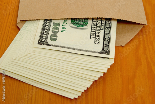 Photo: Dollars in an envelope. Dollars in an envelope.