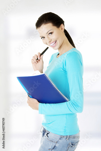 Photo: Happy student woman with notebook Happy student woman with notebook