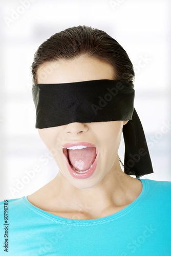 Photo: Portrait of a young blindfold woman screaming Portrait of a young blindfold woman screaming