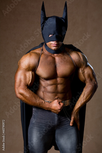 Photo: Handsome strong muscular man in black mask Handsome strong muscular man in black mask