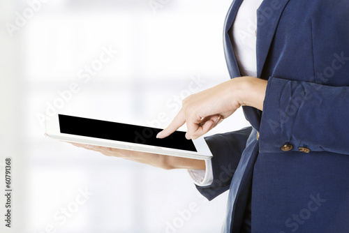 Photo: Attractive businesswoman using tablet computer Attractive businesswoman using tablet computer