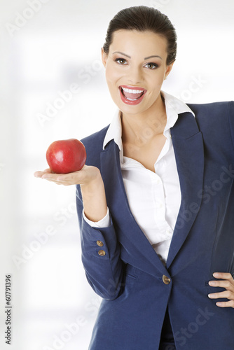 Photo: Attractive businesswoman holding red apple Attractive businesswoman holding red apple