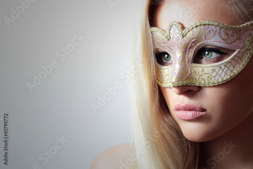 Photo: Beautiful Blond Woman in Carnival Mask.Masquerade.Close-up Beautiful Blond Woman in Carnival Mask.Masquerade.Close-up
