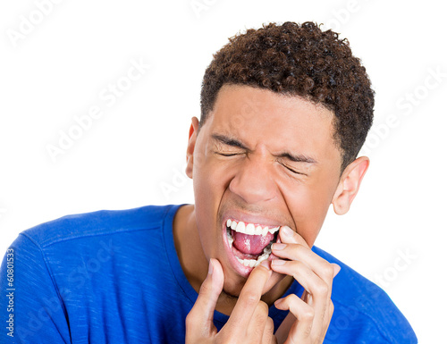 Photo: Sick man with tooth ache, pain, sensitive teeth Sick man with tooth ache, pain, sensitive teeth