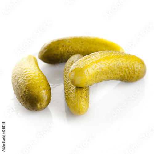 Photo: pickled cucumbers. Gherkins on a white background pickled cucumbers. Gherkins on a white background