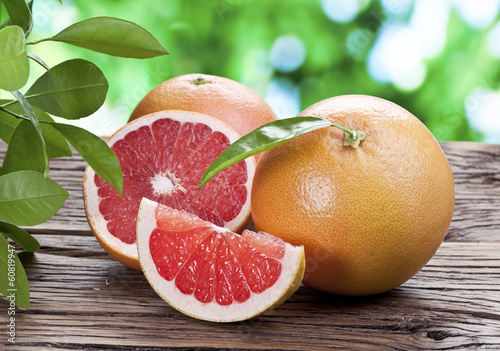 Photo: Grapefruits on a wooden table. Grapefruits on a wooden table.