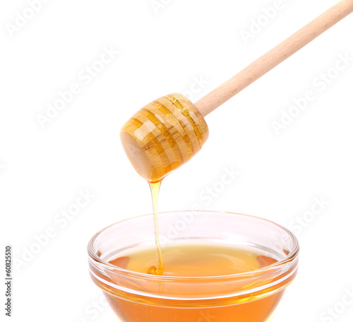 Photo: Bee honey with wooden dipper. Bee honey with wooden dipper.