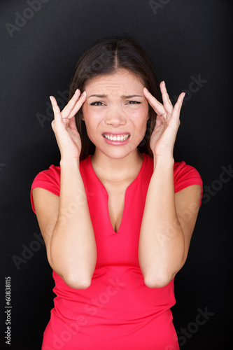 Photo: Stressed woman with headache stress migraine Stressed woman with headache stress migraine